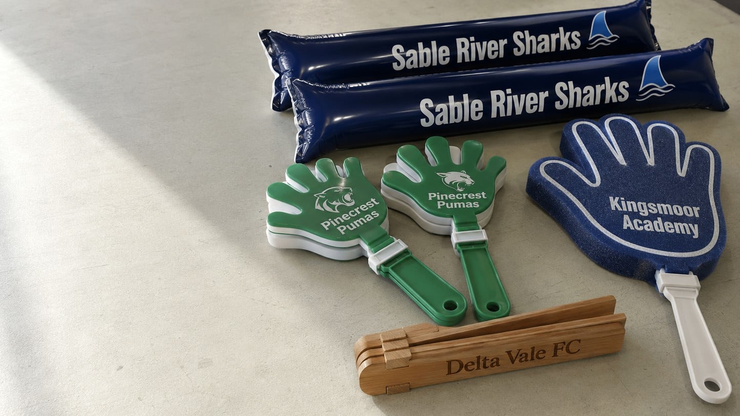 Custom-printed hand clappers and thundersticks laid out on a bright surface